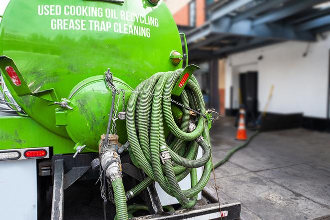 a grease trap being pumped by a sanitation technician in Freeport ME